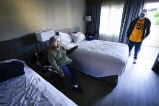 National City, CA - March 21: Erminia Lopez, 81, and her son, Richard Lopez, 59, have been sharing a single room at the Ramada Hotel in National City. The two rented and lived at M Avenue up until the January 22nd flood. The best estimate for the construction repair is possibly in May. (Nelvin C. Cepeda / The San Diego Union-Tribune)