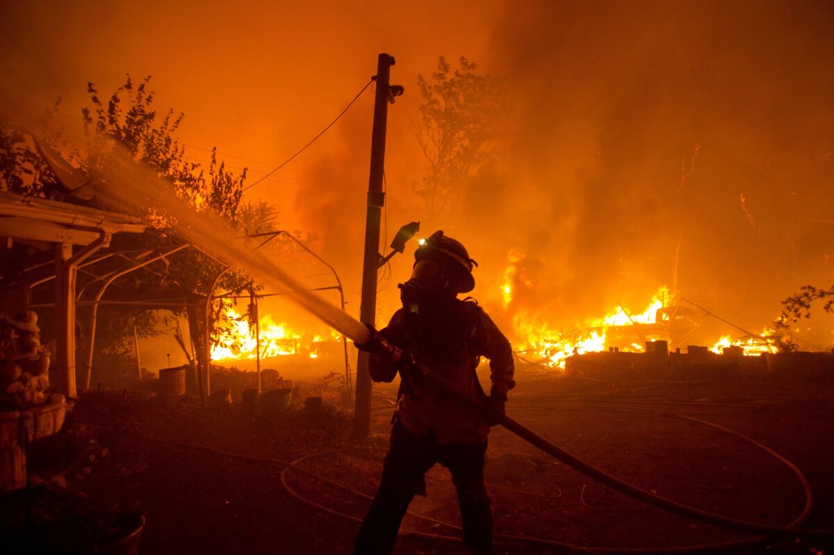 A firefighter works against the Lake Hughes Fire in Angeles National Forest north of Santa Clarita.