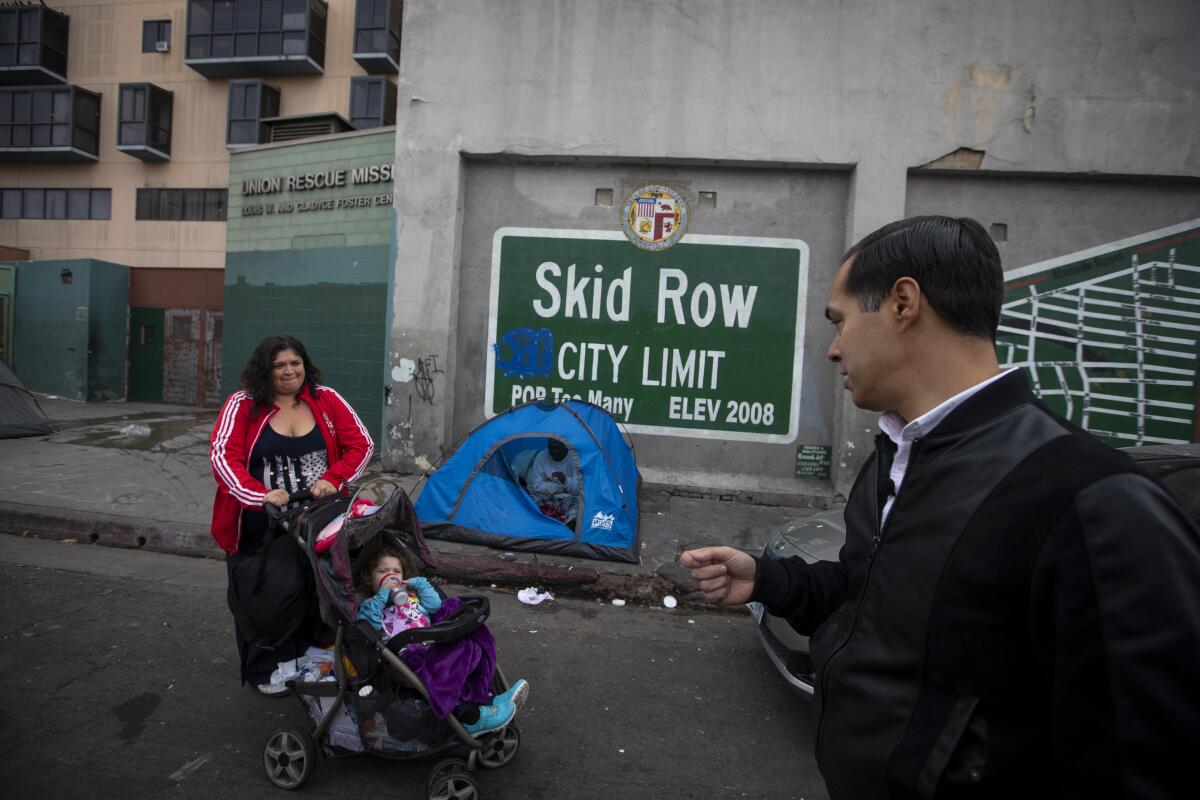 Julián Castro on skid row with a woman and a baby in a stroller