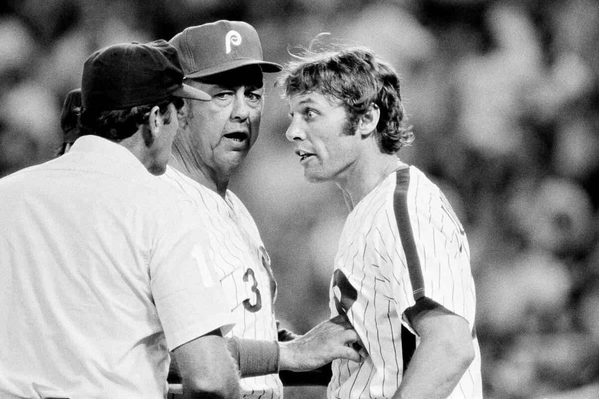 Philadelphia Phillies manager Danny Ozark gets between umpire Jerry Crawford and outfielder Jay Johnstone.