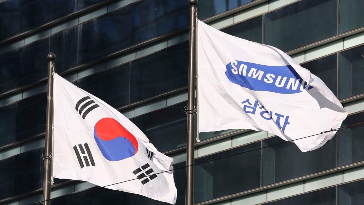 The company flag of Samsung Electronics flutters next to the South Korean national flag in Seoul.