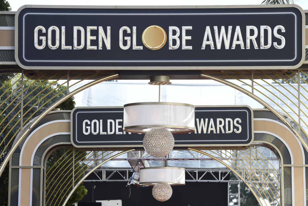 FILE - Event signage appears above the red carpet at the 77th annual Golden Globe Awards on Jan. 5, 2020, in Beverly Hills, Calif. The 80th annual Golden Globe Awards will take place on Tuesday, Jan. 10. (Photo by Jordan Strauss/Invision/AP, File)