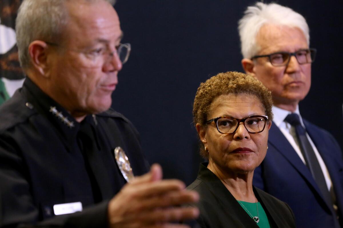 LAPD Chief Michael Moore, from left, with Los Angeles Mayor Karen Bass and Los Angeles District Attorney George Gascon.