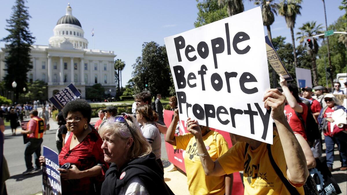 Supporters of rent control measures march past the Capitol in Sacramento in April 2018.