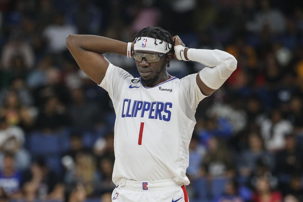 Clippers guard Reggie Jackson has his hands behind his head on court