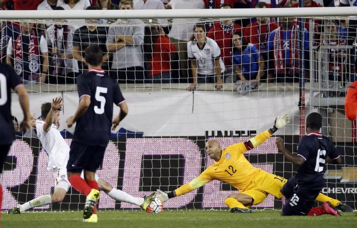 Costa Rica's Joel Campbell scores a goal on United States goalkeeper Tim Howard, center, during the second half of friendly match on Oct. 13.