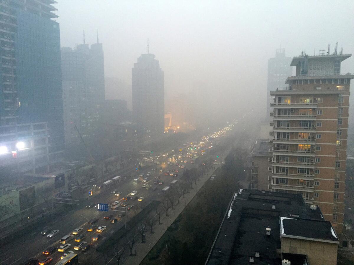Smog hangs over Beijing's main boulevard, Chang'an Avenue, looking west toward the Forbidden City.