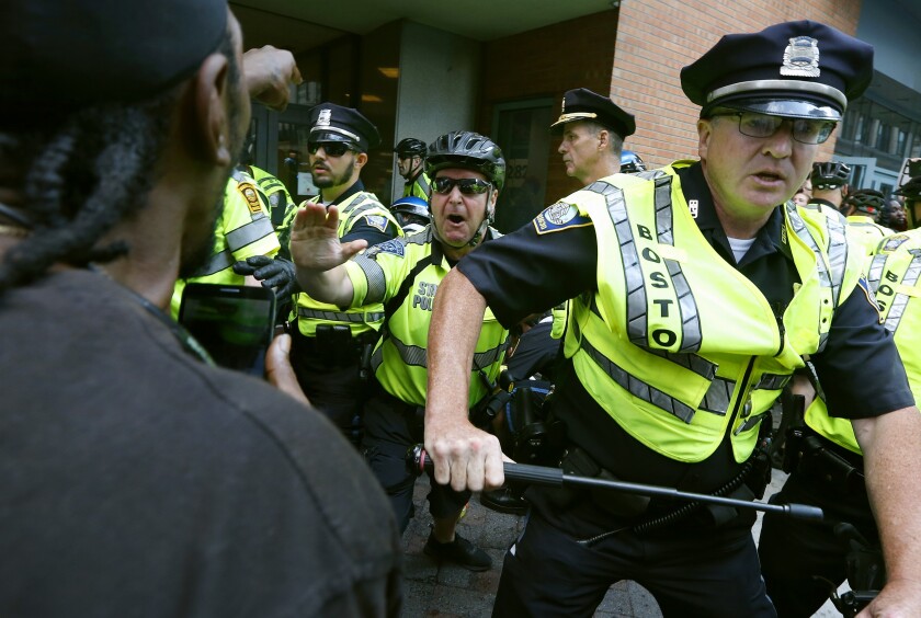 FILE - In this Aug. 19, 2017, file photo, counterprotesters clash with police following a "Free Speech" rally staged by conservative activists in Boston. Boston's police department remains largely white in 2021, despite vows for years by city leaders to work toward making the police force look more like the community it serves. (AP Photo/Michael Dwyer, File)