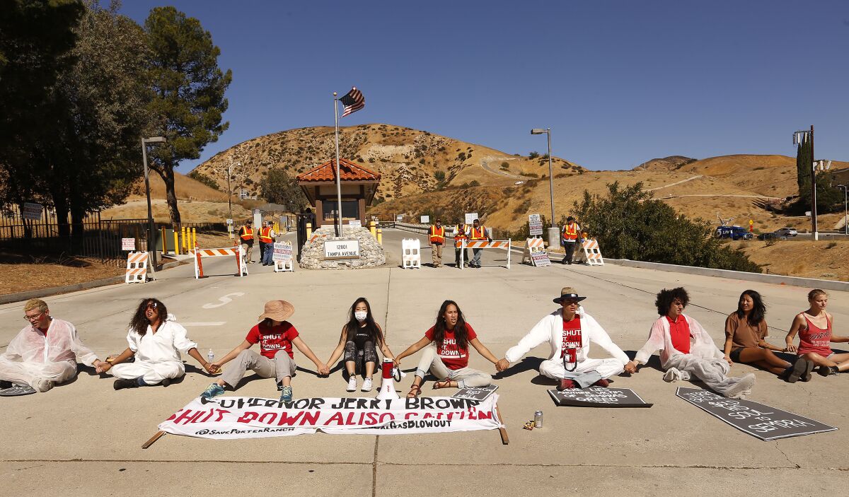 Protestors held hands after residents staged a sit in blocking the entrance to the SoCal Gas Company Aliso Canyon facility 