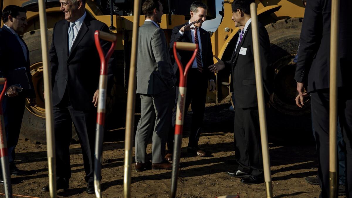 Mayor Eric Garcetti, center, at a groundbreaking ceremony for a 160-unit affordable apartment project next to the 110 Freeway in South Los Angeles on Jan. 26, 2017.