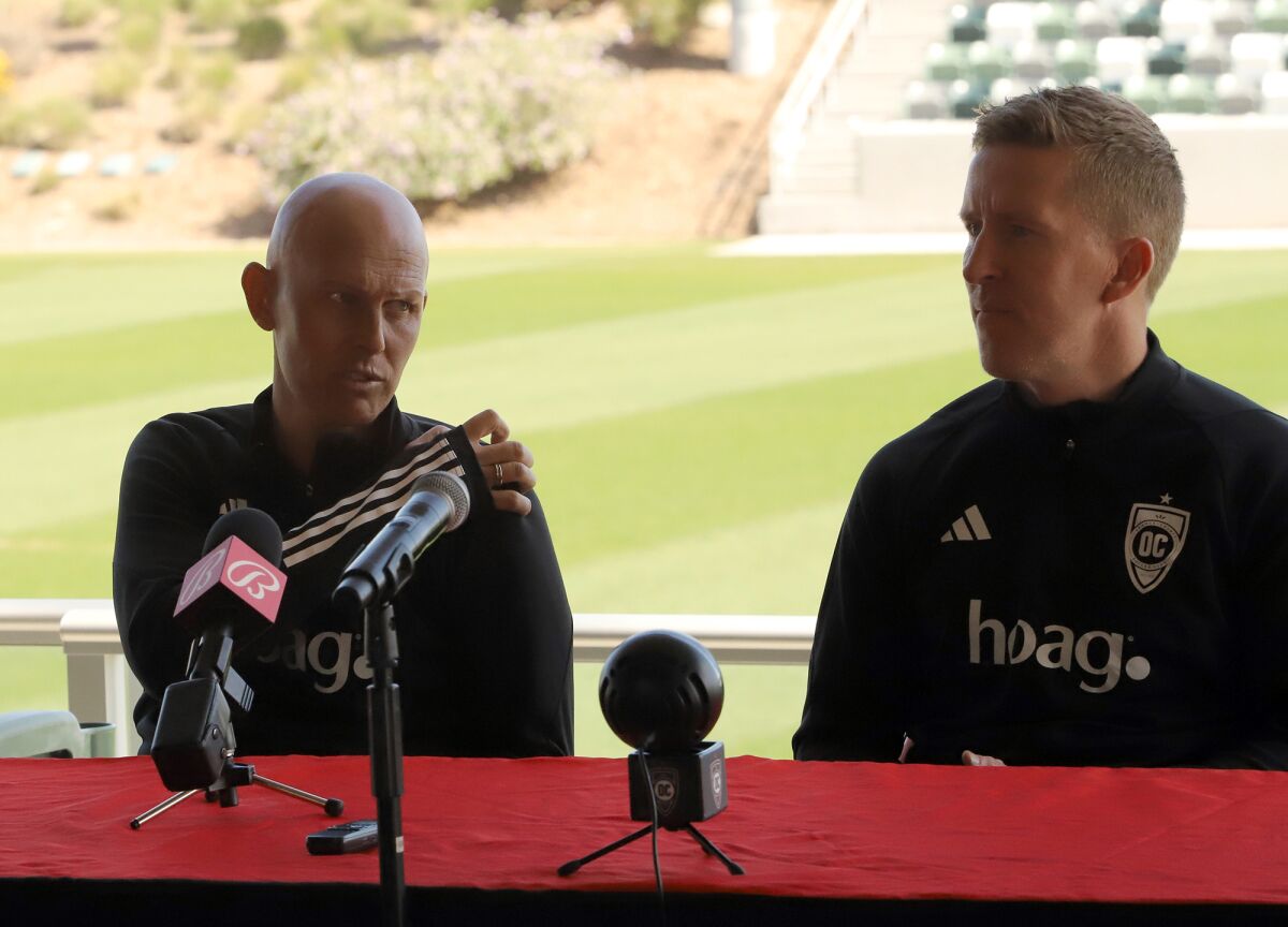 Orange County Soccer Club head coach Richard Chaplow, left, and first assistant Morten Karlsen answer questions Tuesday.