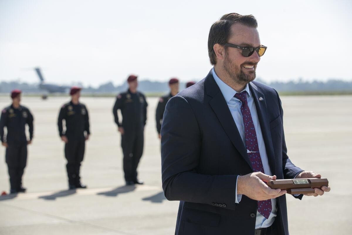 Kevin Elliott, the director of the Pacific Airshow, receives an honorary baton from the U.S. Army Golden Knights on Thursday.