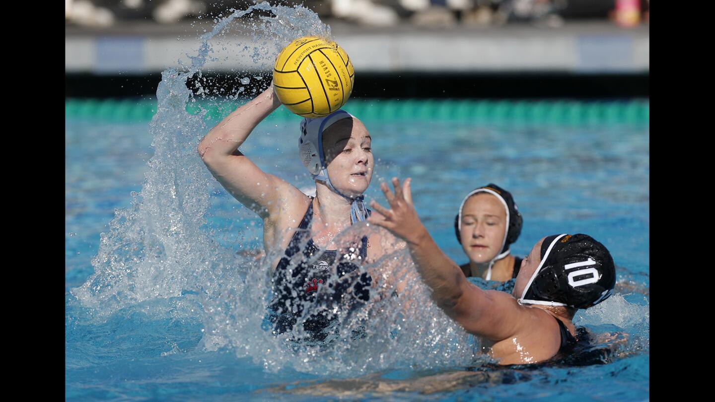 Corona del Mar High's Sophie Wallace, left, competes against Foothill during the first half in the semifinals of the Holiday Cup girls' water polo tournament at Newport Harbor High on Saturday, December 29, 2018.