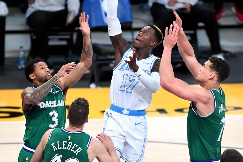 The Lakers' Dennis Schroder makes a basket against the Dallas Mavericks on Dec. 25, 2020.