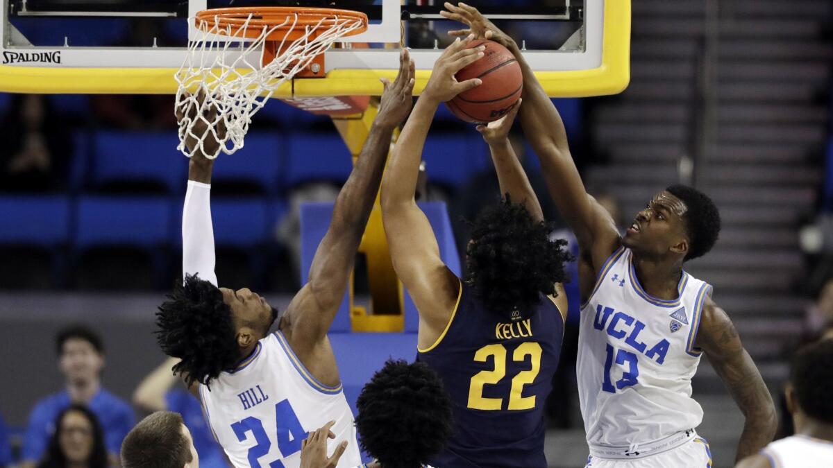 UCLA guard Kris Wilkes and forward Jalen Hill block a shot from California forward Andre Kelly during a Bruins win on Jan. 5.