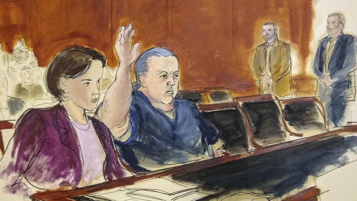 Cesar Sayoc, shown raising his hand in this courtroom artist's rendering, is charged with sending pipe bombs to prominent critics of President Trump. He is expected to plead guilty at a hearing in New York on Thursday, March 21.