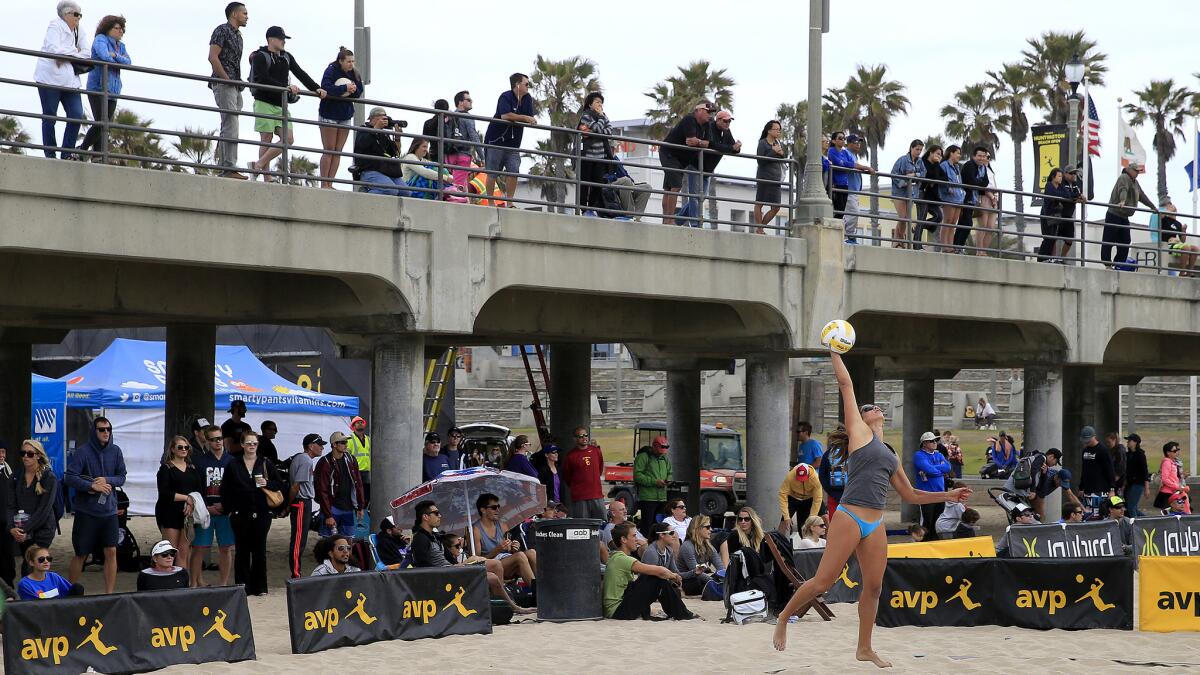 Fans watch beach volleyball players from behind and above the court during the AVP Huntington Beach Open, which runs through Sunday.