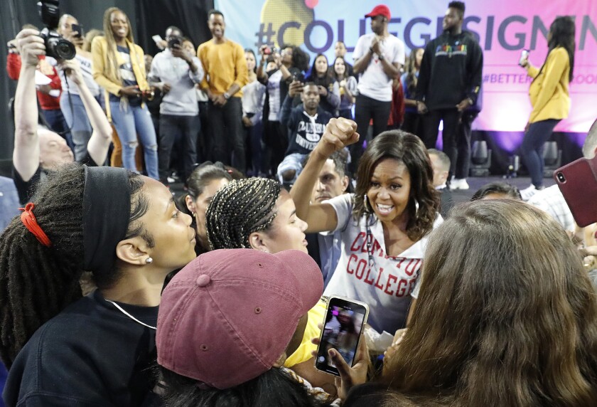Former First Lady Michelle Obama greets the crowd at Pauley Pavilion on the UCLA campus on Wednesday.