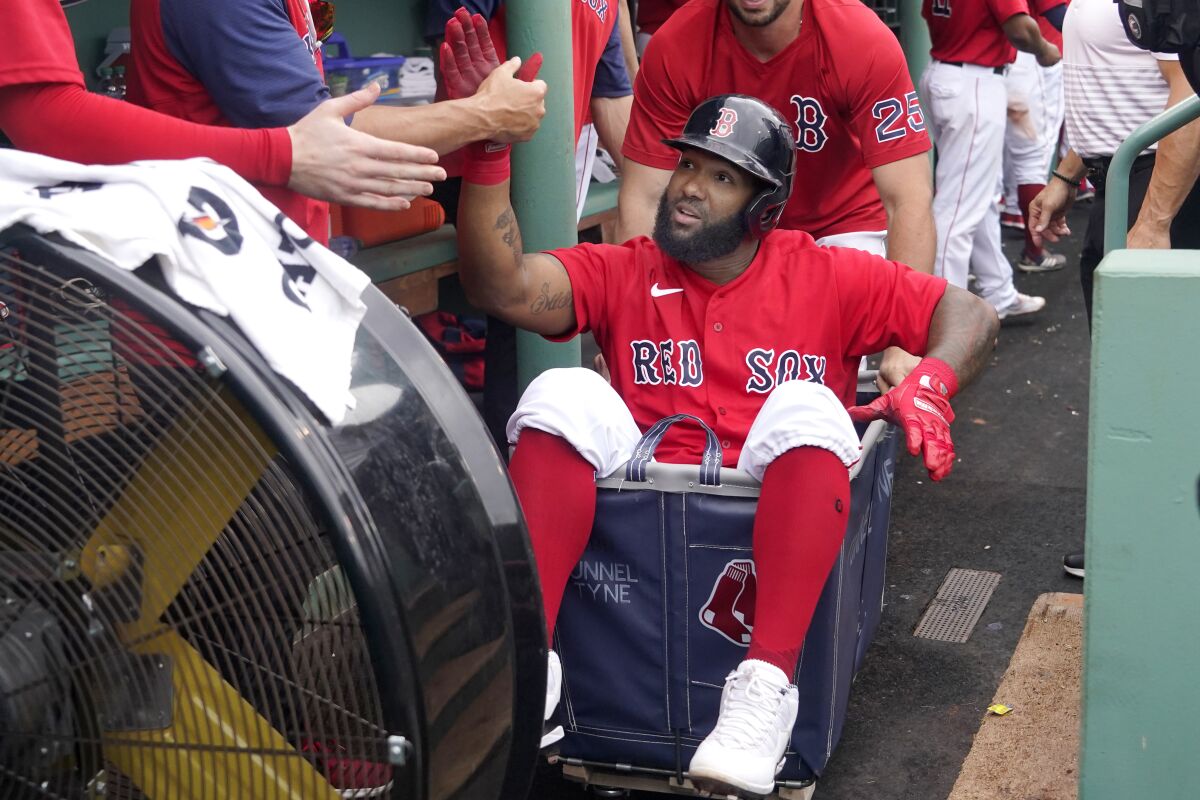 Boston Red Sox's Danny Santana celebrates his three-run homer against the Kansas City Royals with a dugout ride in a laundry cart in the fourth inning of a baseball game at Fenway Park, Thursday, July 1, 2021, in Boston. (AP Photo/Elise Amendola)