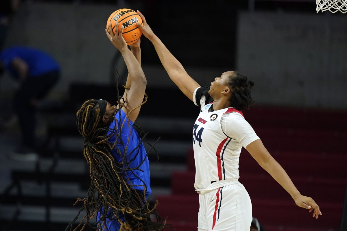 Dayton center Tenin Magassa (34) blocks a shot by DePaul forward Aneesah Morrow, left, during the second half of a First Four game in the NCAA women's college basketball tournament, Wednesday, March 16, 2022, in Ames, Iowa. (AP Photo/Charlie Neibergall)