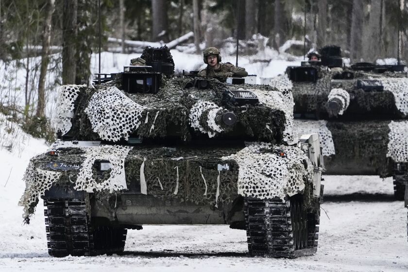 FILE - Denmark's Leopard 2A7 tanks move during the Winter Camp 23 military drills near Tapa, Estonia, Sunday, Feb. 5, 2023. Denmark’s centrist government said Tuesday that it wants to invest some 143 billion kroner ($20.6 billion) in the Danish defense over the next decade, citing a “serious threat picture.” (AP Photo/Pavel Golovkin, File)