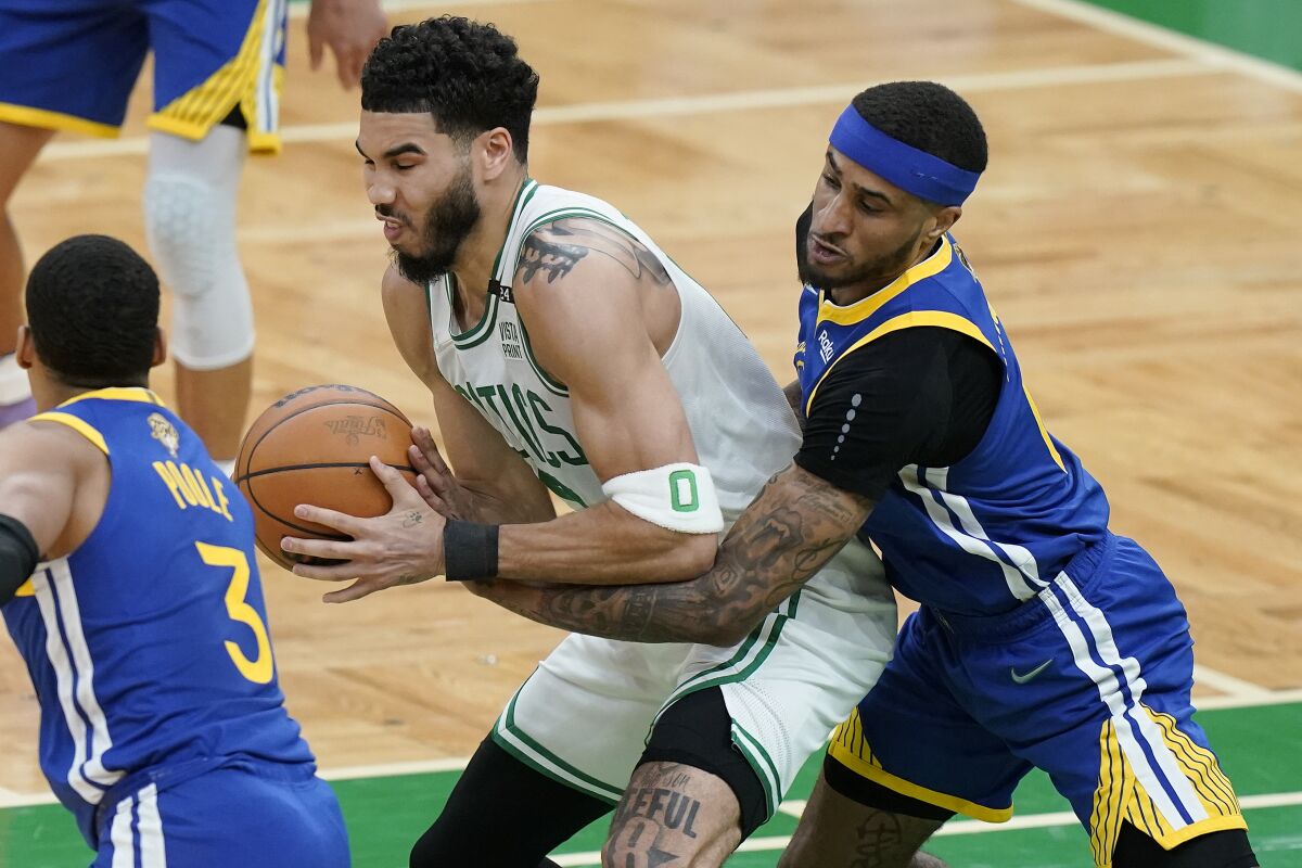 Golden State Warriors guard Gary Payton II (0) tries to strip the ball from Boston Celtics forward Jayson Tatum (0) during the first quarter of Game 6 of basketball's NBA Finals, Thursday, June 16, 2022, in Boston. (AP Photo/Steven Senne)