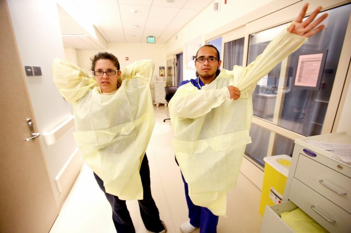 Nurses gown up before seeing a patient. A new study finds that hospital workers are at risk of becoming contaminated with dangerous pathogens, even when they put on and remove their gowns and gloves correctly.