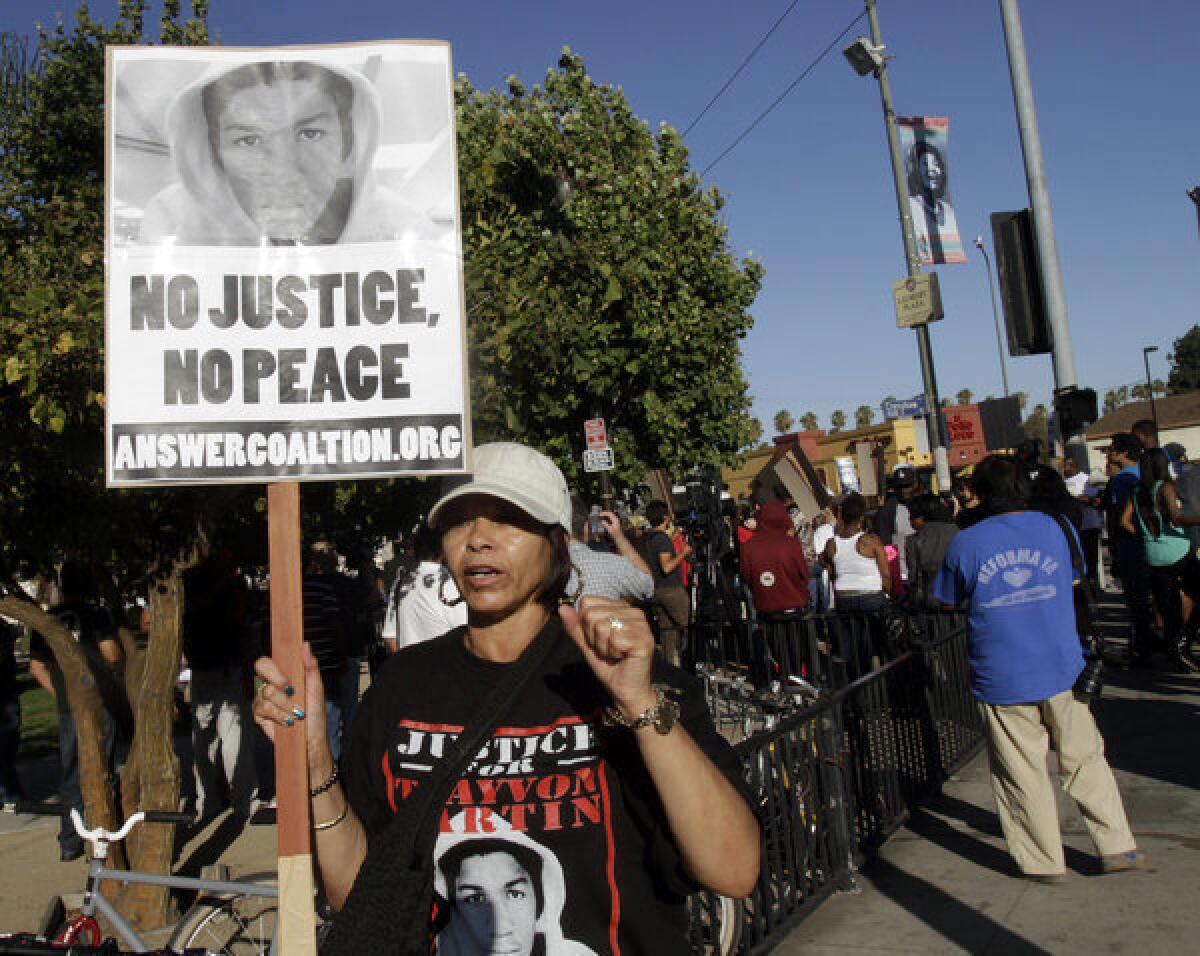 Gwen Lewis protesting in Leimert Park on Crenshaw Boulevard in Los Angeles on Monday evening.