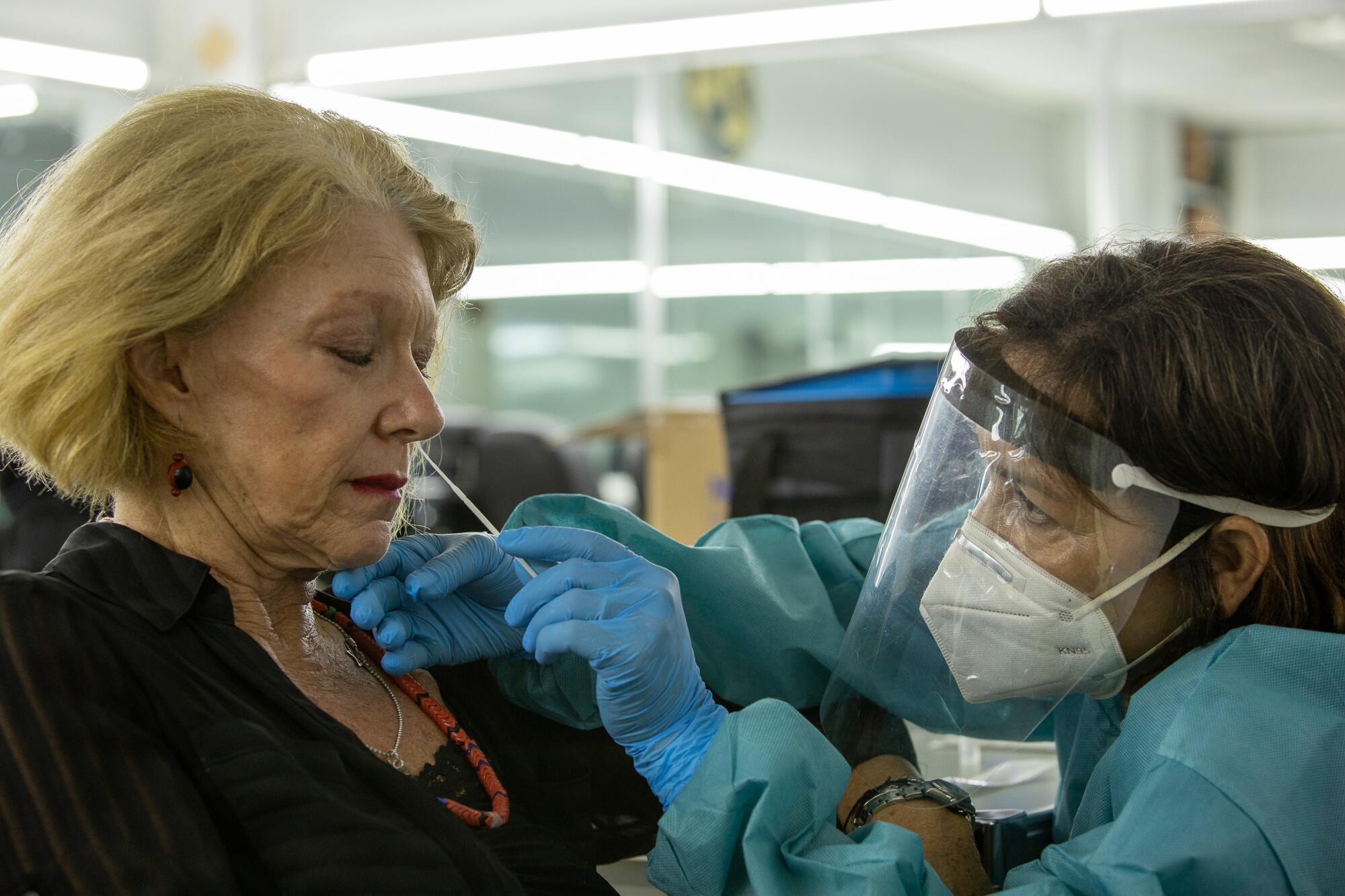 Director Betty Kaplan receives an on-set COVID-19 test during filming of "Simone."