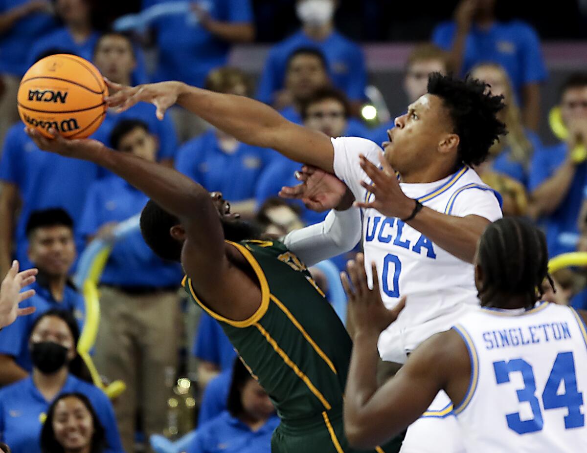 UCLA guard Jaylen Clark, right, blocks a shot attempt by Norfolk State guard Joe Bryant Jr.
