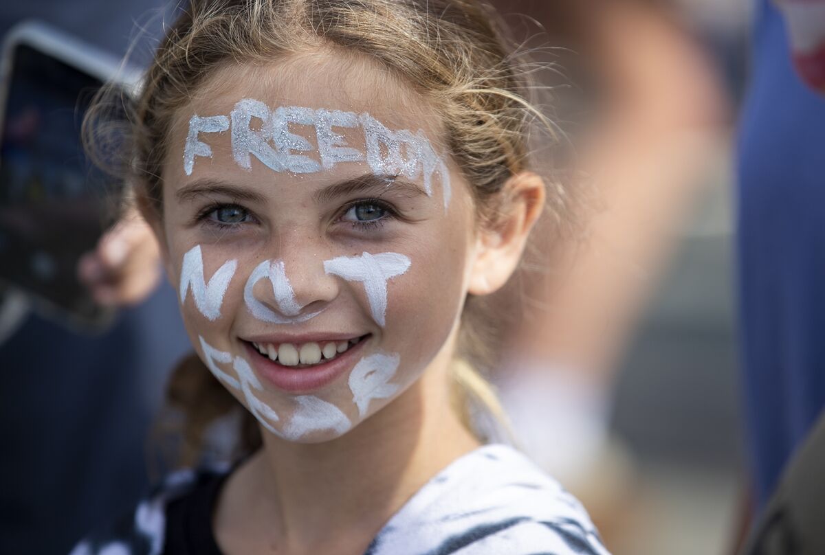 Sydney Salas, 9, has her face painted with the words "Freedom Not Fear."