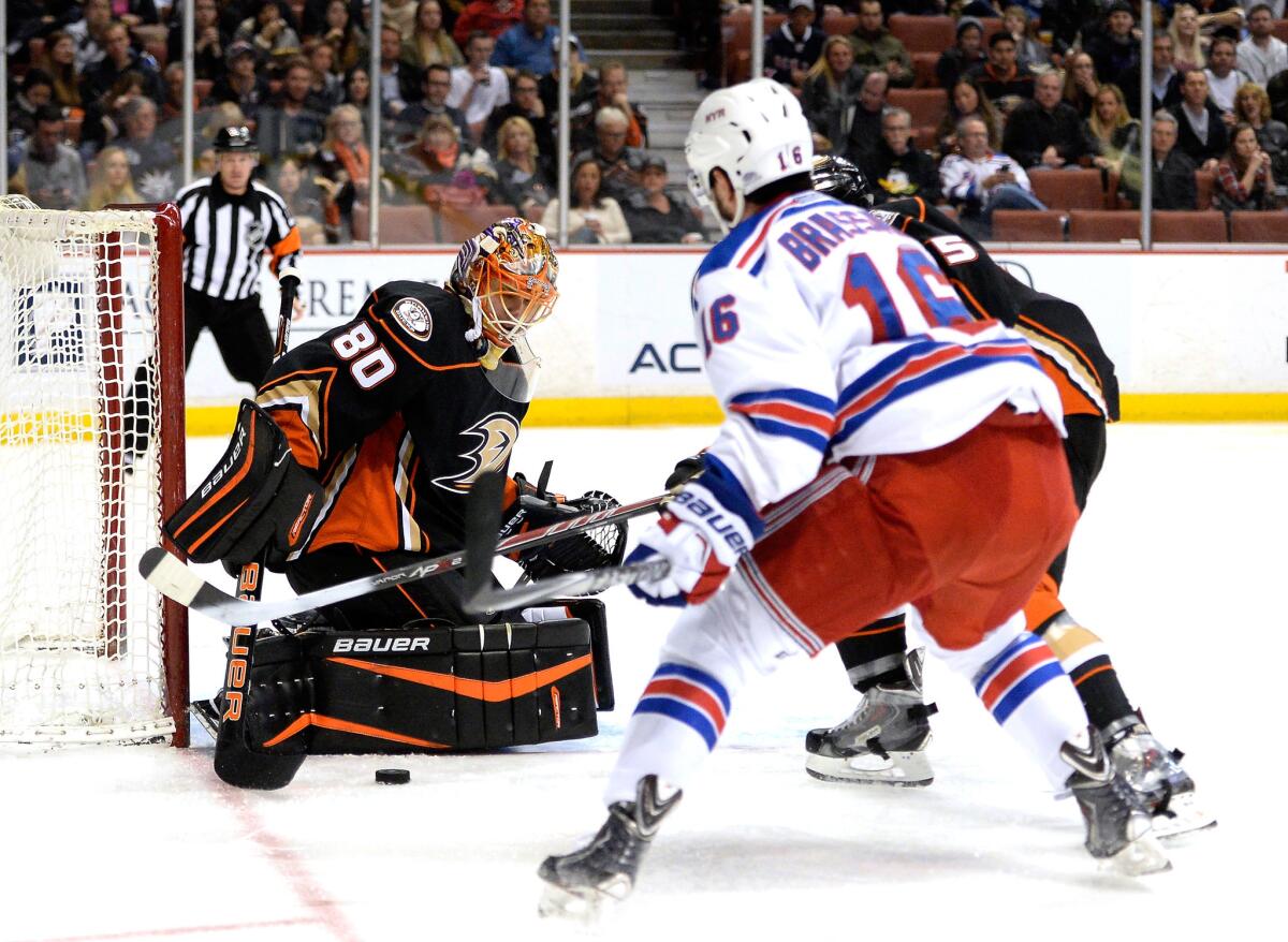 Ducks goalie Ilya Bryzgalov makes a save as the New York Rangers' Derick Brassard moves in for a rebound at Honda Center on Jan. 7.