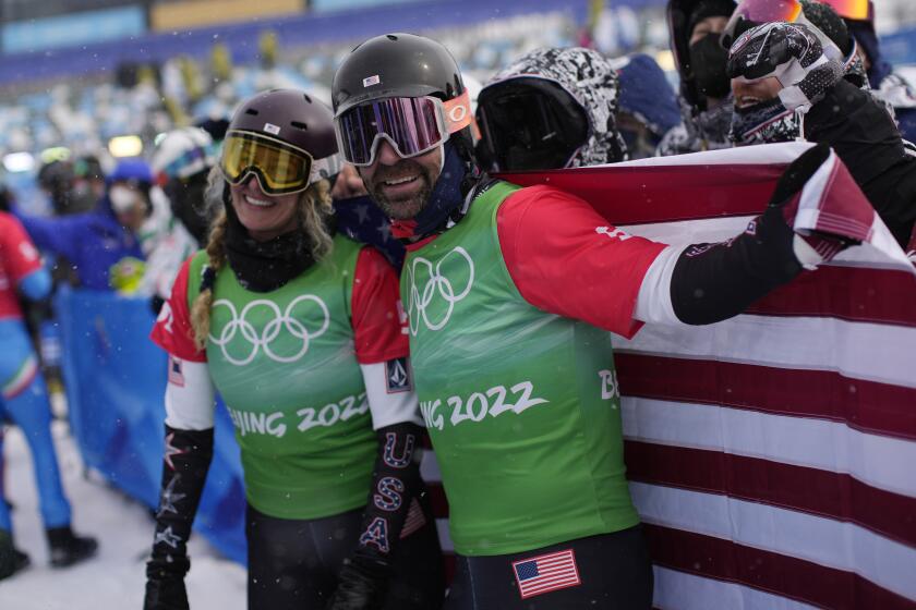 Gold medal winners United States' Lindsey Jacobellis and Nick Baumgartner celebrate after the mixed team.