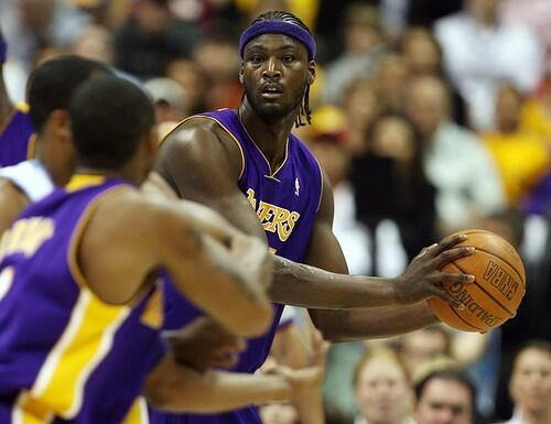 Lakers center Kwame Brown looks to pass the ball to guard Kobe Bryant as Denver Nuggets forward Greg Buckner.