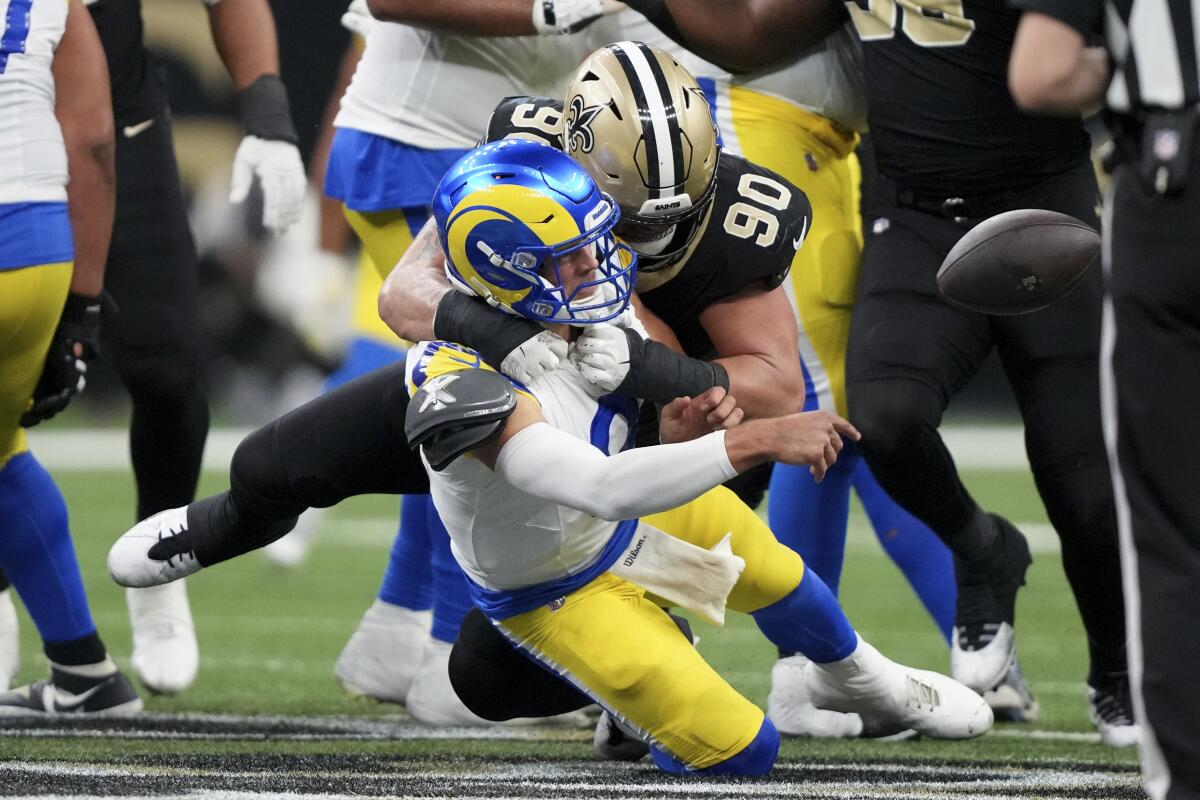 Rams quarterback Matthew Stafford (9) is sacked Saints defensive tackle Bryan Bresee (90).