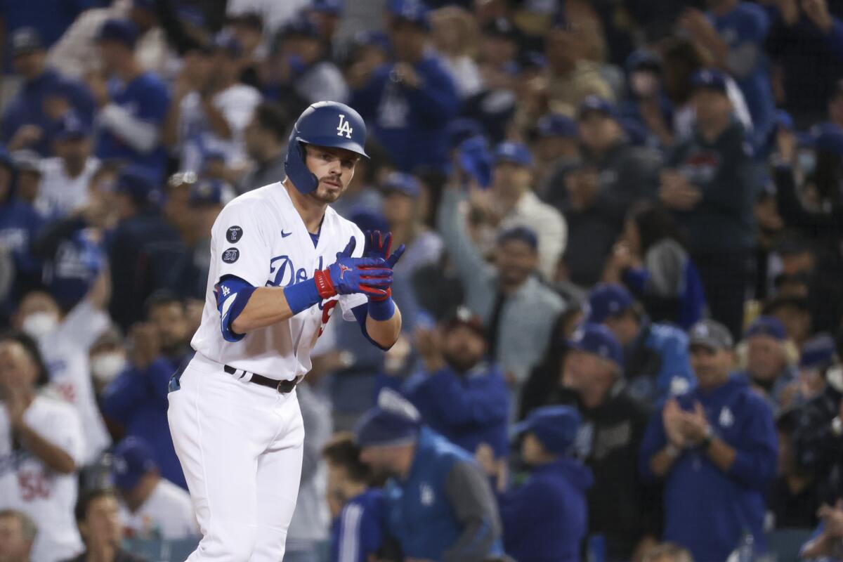 Dodgers baserunner Gavin Lux claps at first base after hitting a single in the second inning.