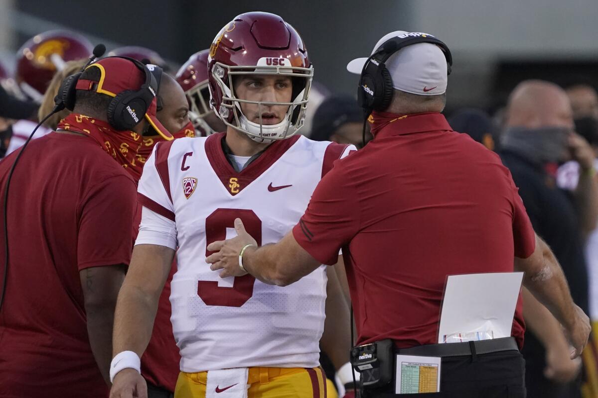 USC quarterback Kedon Slovis speaks with coach Clay Helton during a win over Arizona on Nov. 14.