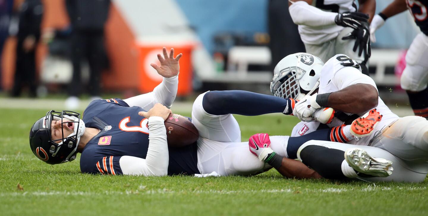Jay Cutler is sacked by Raiders defensive end Justin Tuck.