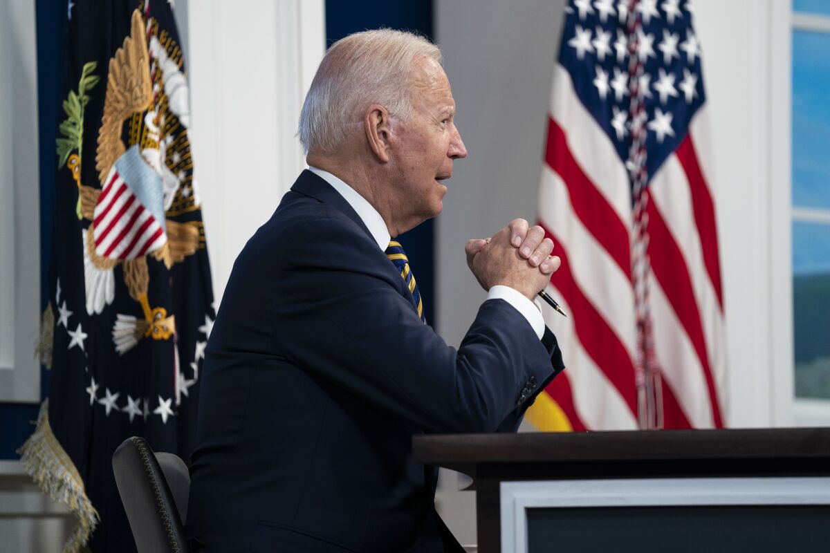 President Joe Biden sitting at a desk.