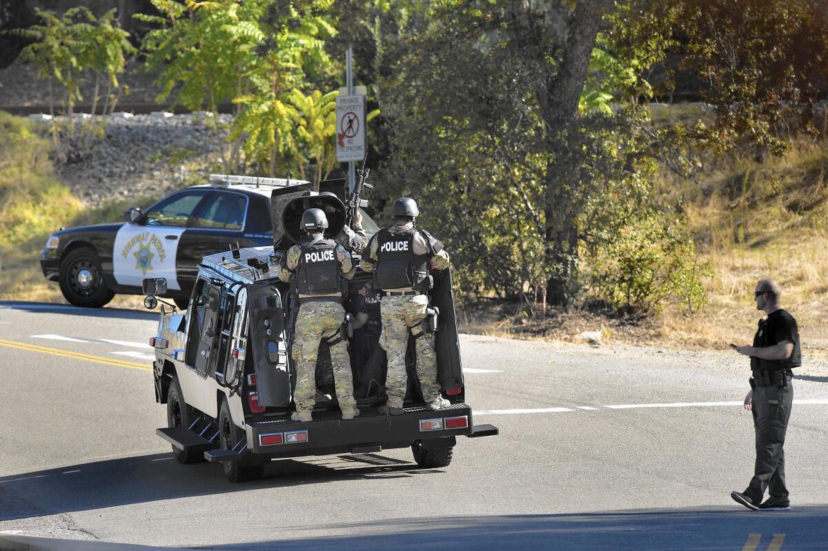 A SWAT team arrives at the area in Auburn where Placer County Sheriff's Det. Michael David Davis Jr. and Deputy Jeff Davis were shot Saturday. Jeff Davis was wounded in the arm; Michael Davis later died. The two lawmen are not related.
