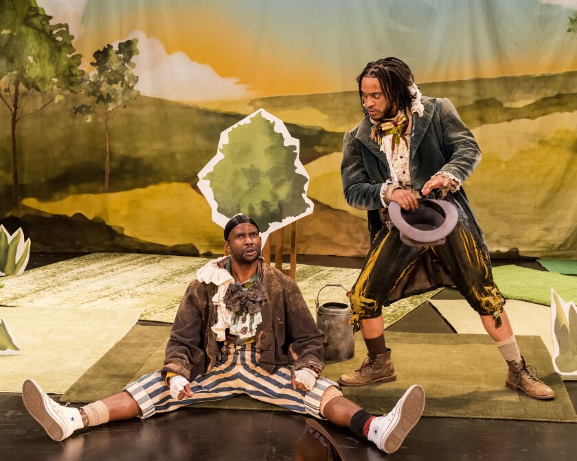 Two Black men onstage in minstrel costumes
