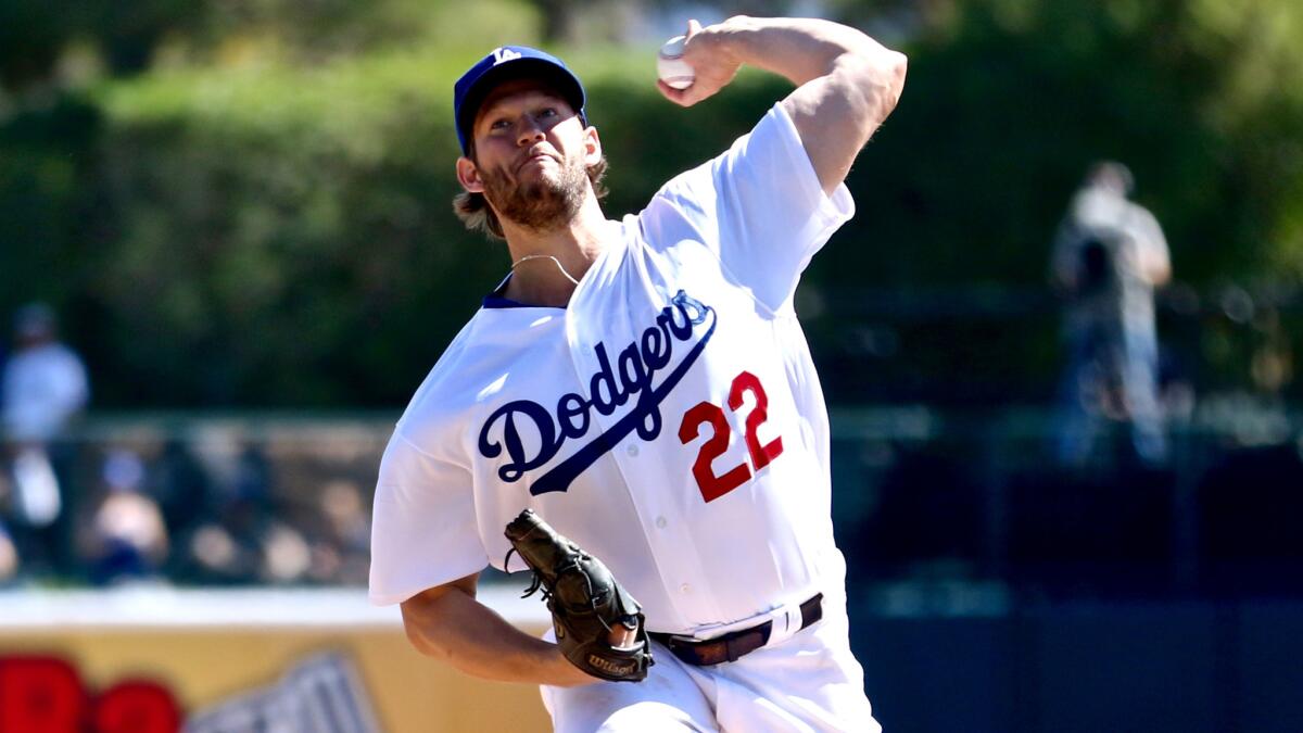 Dodgers starter Clayton Kershaw, shown warming up before an exhibition game last month, gave up two runs in the first inning against the Mariners on Wednesday.