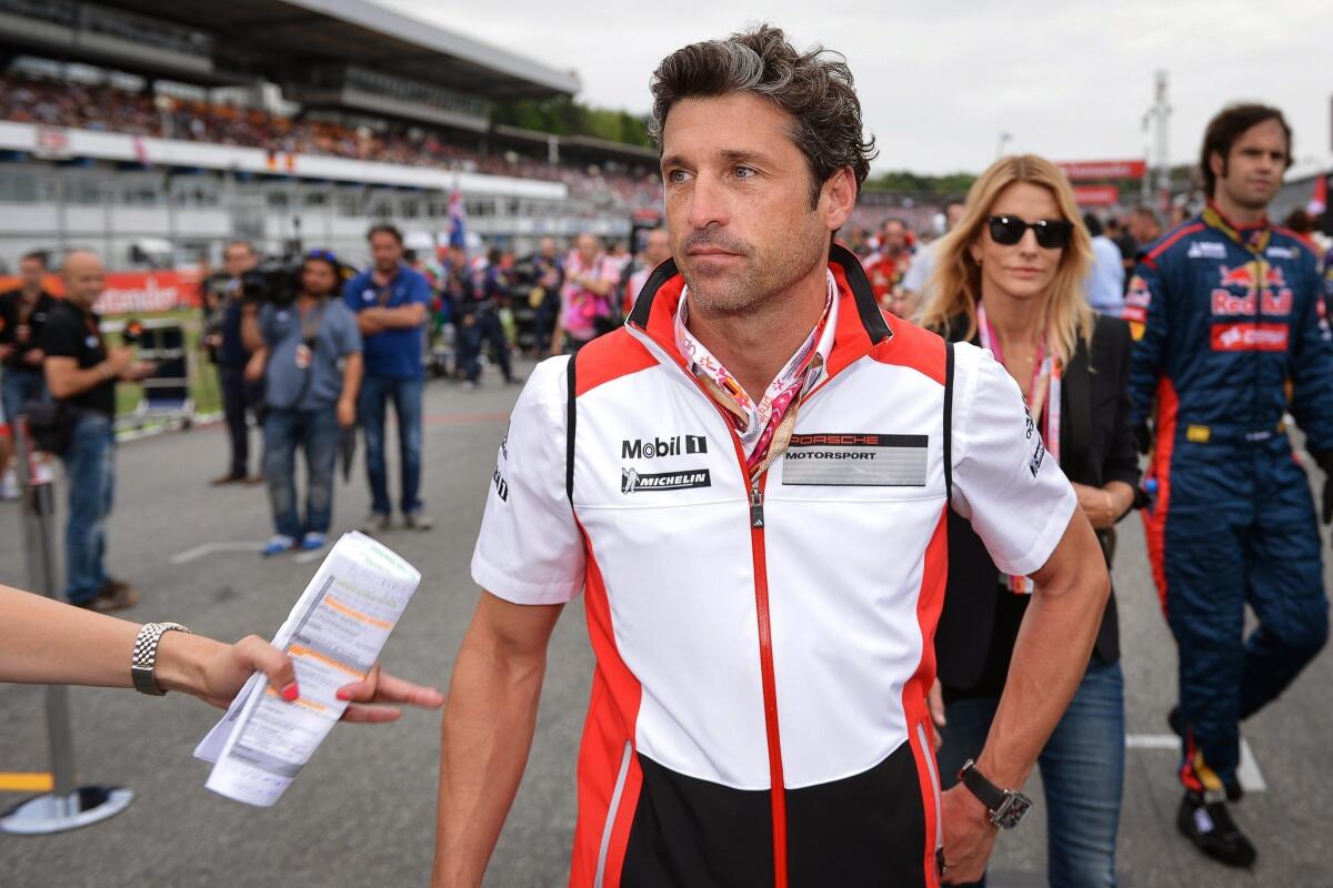 Actor Patrick Dempsey, shown at the German Grand Prix on Sunday, says his "Grey's Anatomy" contract stipulates that he can race.