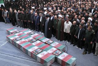 Prayer over the flag-draped coffins of the Revolutionary Guards members who were killed in an airstrike in Syria.
