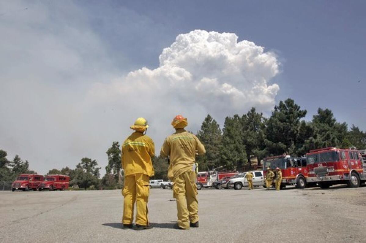 Smoke rises above Mt. Wilson. Fire officials came to Sacramento to seek legislators' help.