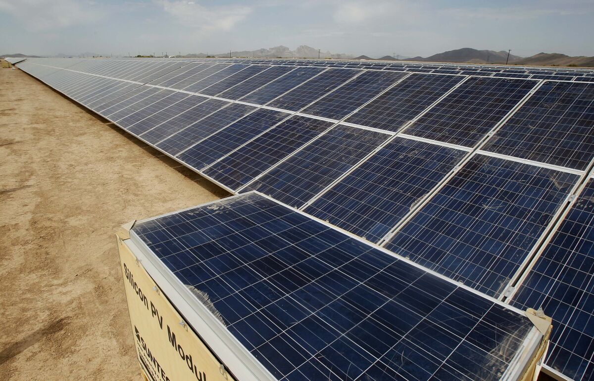 A row of solar panels in the desert