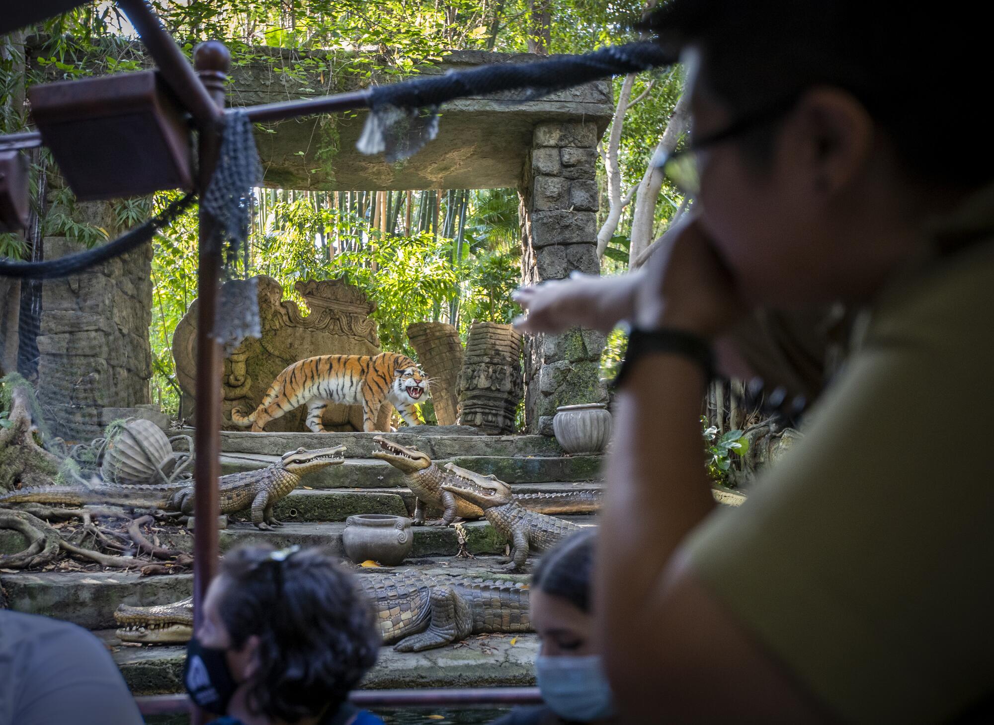 Skipper Amanda Beth Lorenzo leads guests on a journey past a Bengal tiger amid ruins on the Jungle Cruise