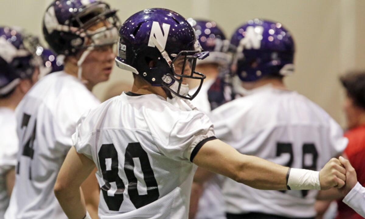 Northwestern wide receiver Austin Carr, center, takes part in spring practice in Evanston, Ill., on April 1. Northwestern has filed an appeal with the National Labor Relations Board over a regional director's decision that the school's scholarship football players can unionize.