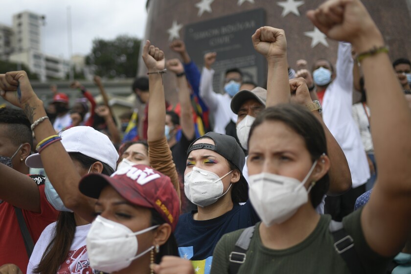 Venezuelan government supporters gather on Bolivar Avenue in Caracas, Venezuela, Saturday, May 8, 2021, during a gathering to show solidarity with the protesters in Colombia who were against a proposed tax plan, since withdrawn by the president. (AP Photo/Matias Delacroix)