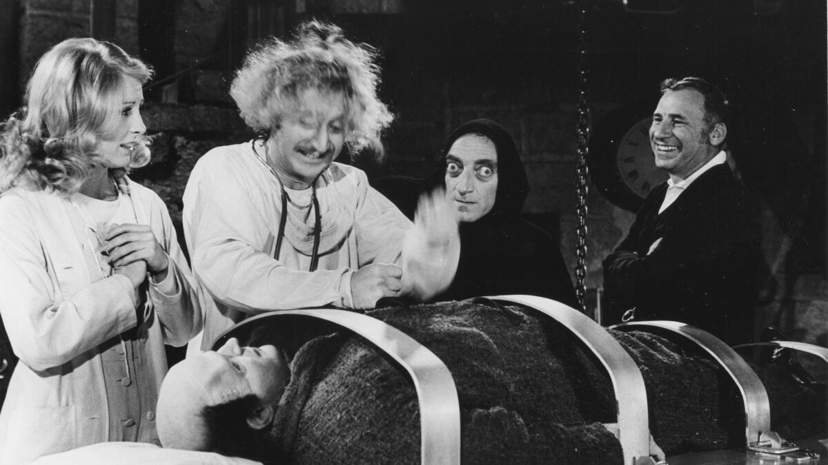 Brooks, right, directs, from left, Teri Garr, Gene Wilder, Marty Feldman, and Peter Boyle (lying down) on the set of "Young Frankenstein" on March 27, 1974.